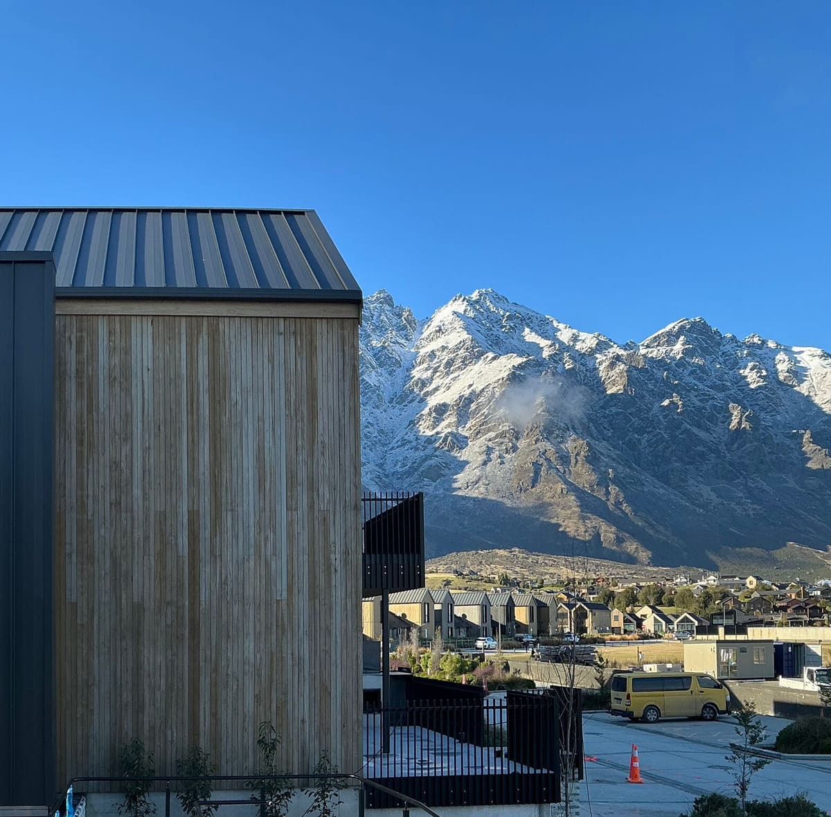 Black balustrade beside cedar cladding with mountain views, Queenstown