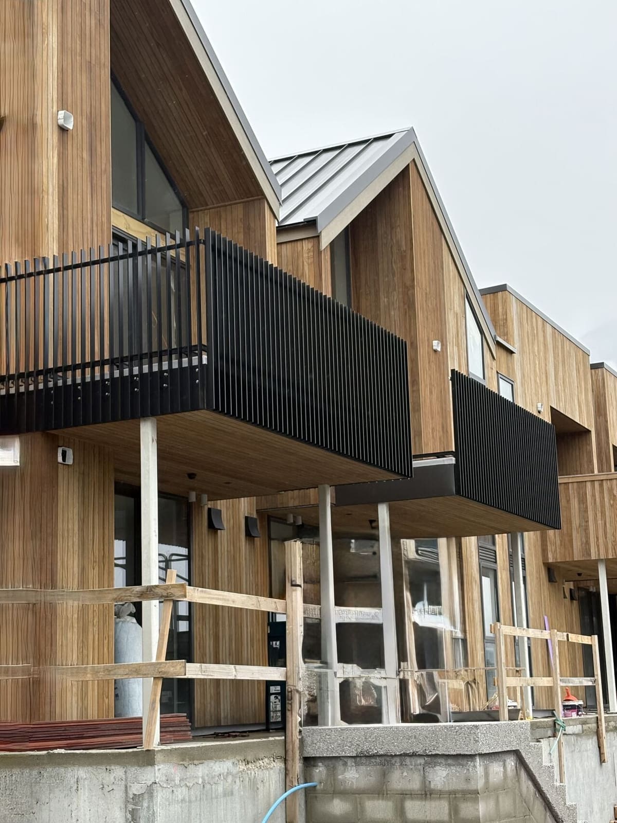 Black aluminium slat balustrade on a cedar-clad balcony, Arthurs Point