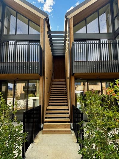 Black aluminium slat balustrades framing a timber entry stair, Arthurs Point