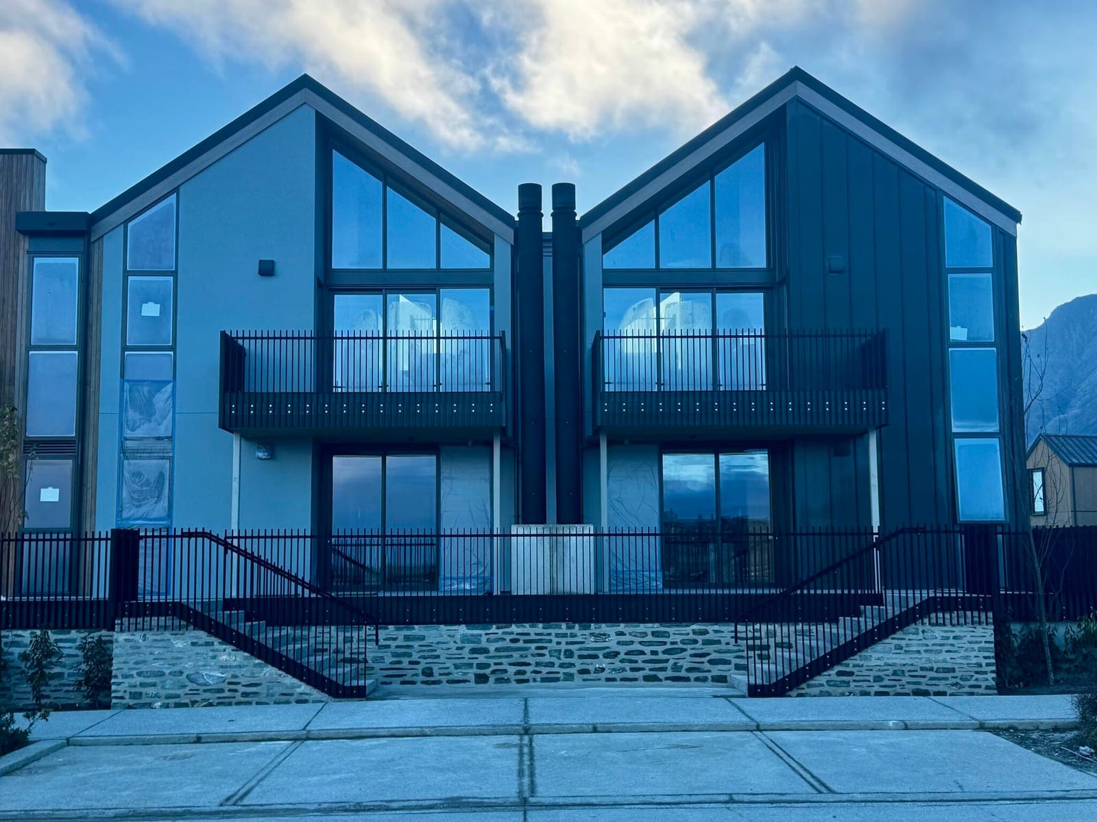 Black tubular balustrades on twin gable townhouses, Arthurs Point