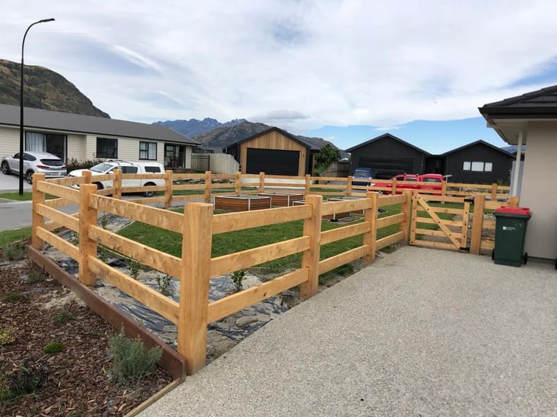 Macrocarpa post and rail fencing with mountain backdrop, Queenstown