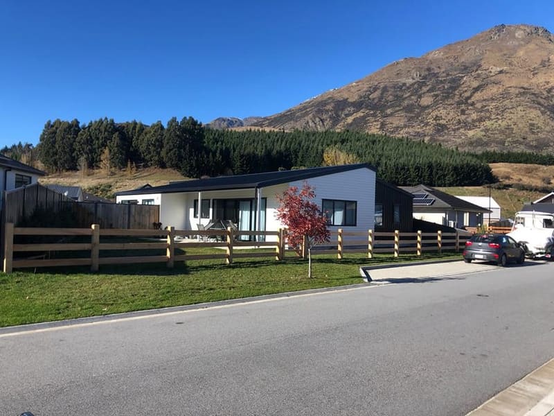 Macrocarpa post and rail fencing with autumn foliage and Queenstown mountains