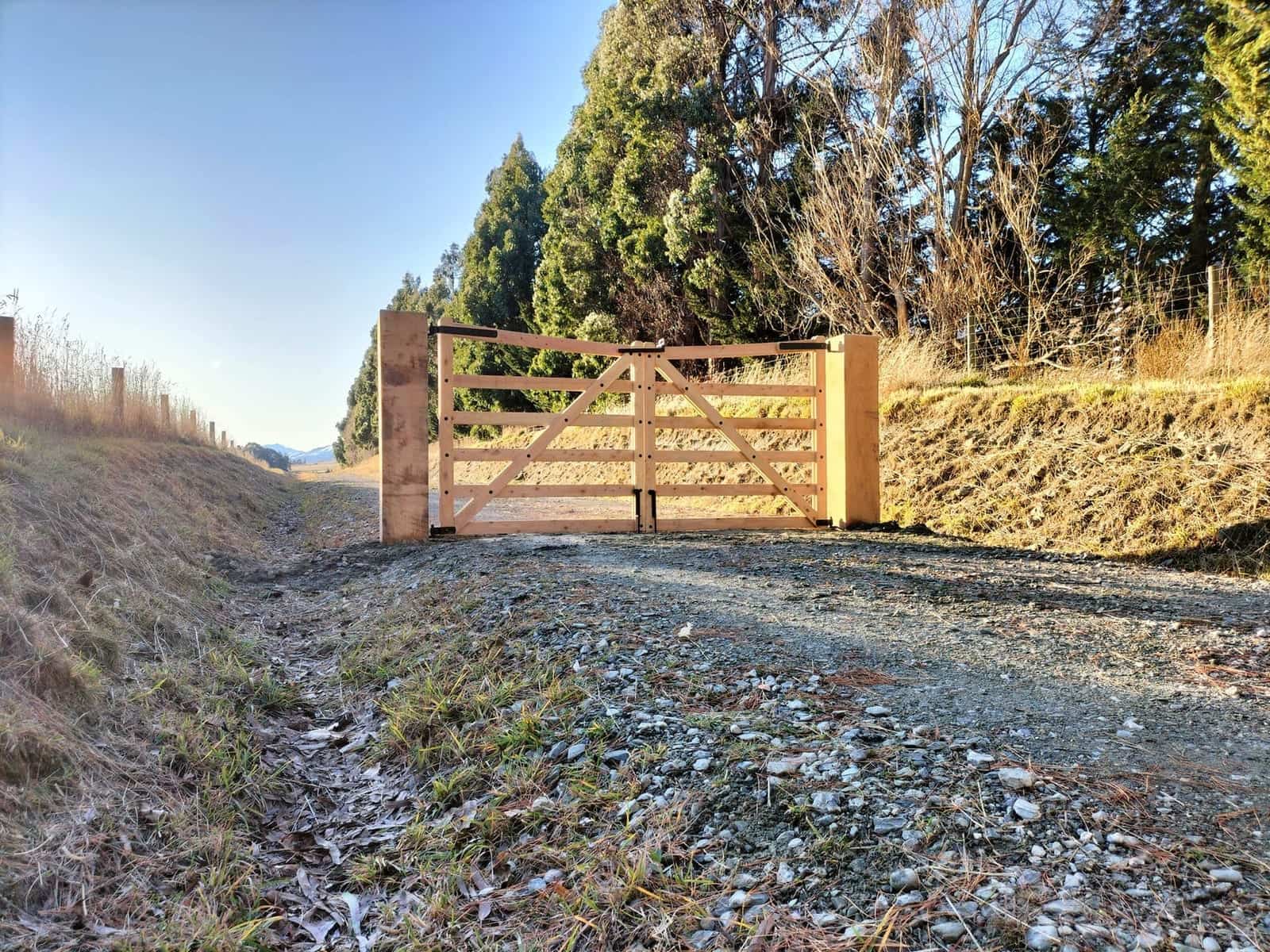 Macrocarpa gate on a frosty rural property with mountain views, Central Otago