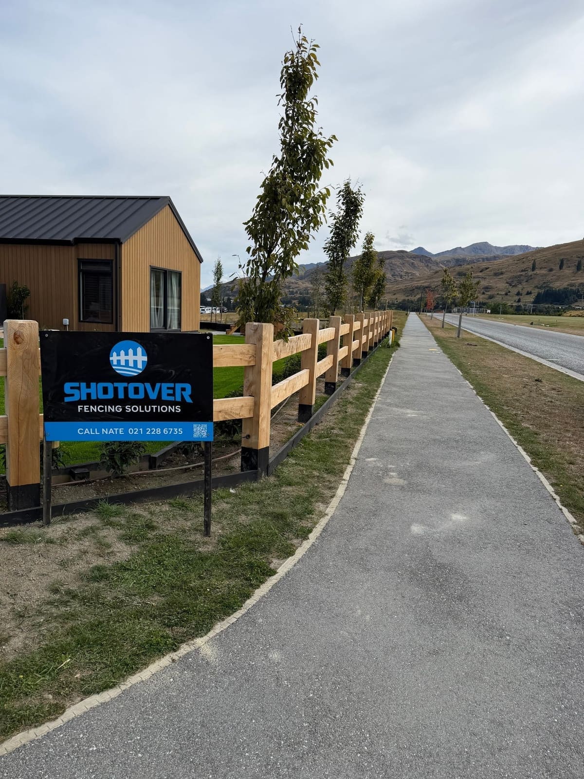 Macrocarpa fencing with subdivision signage at Hanley's Farm, Queenstown