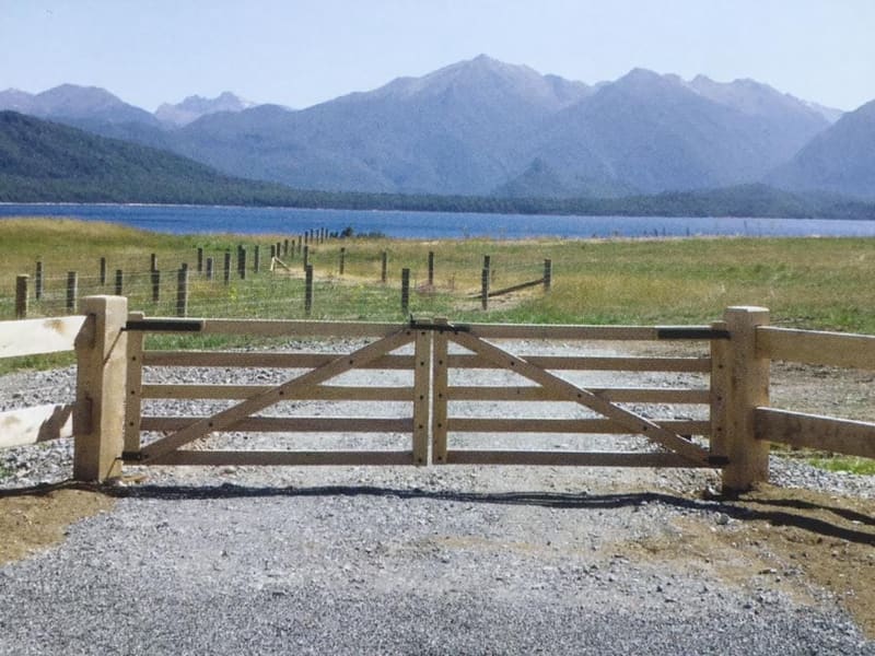 Rural macrocarpa gate with Lake Wakatipu and mountain views