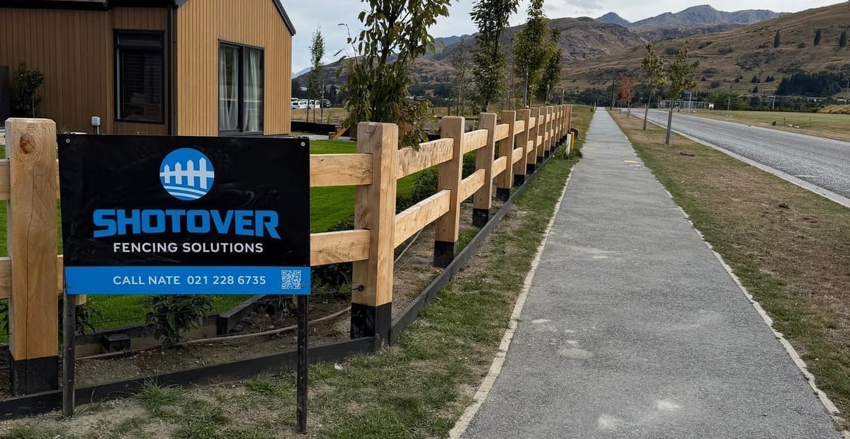 Shotover Fencing Solutions signage beside macrocarpa post and rail fencing in the Parkridge subdivision, Queenstown