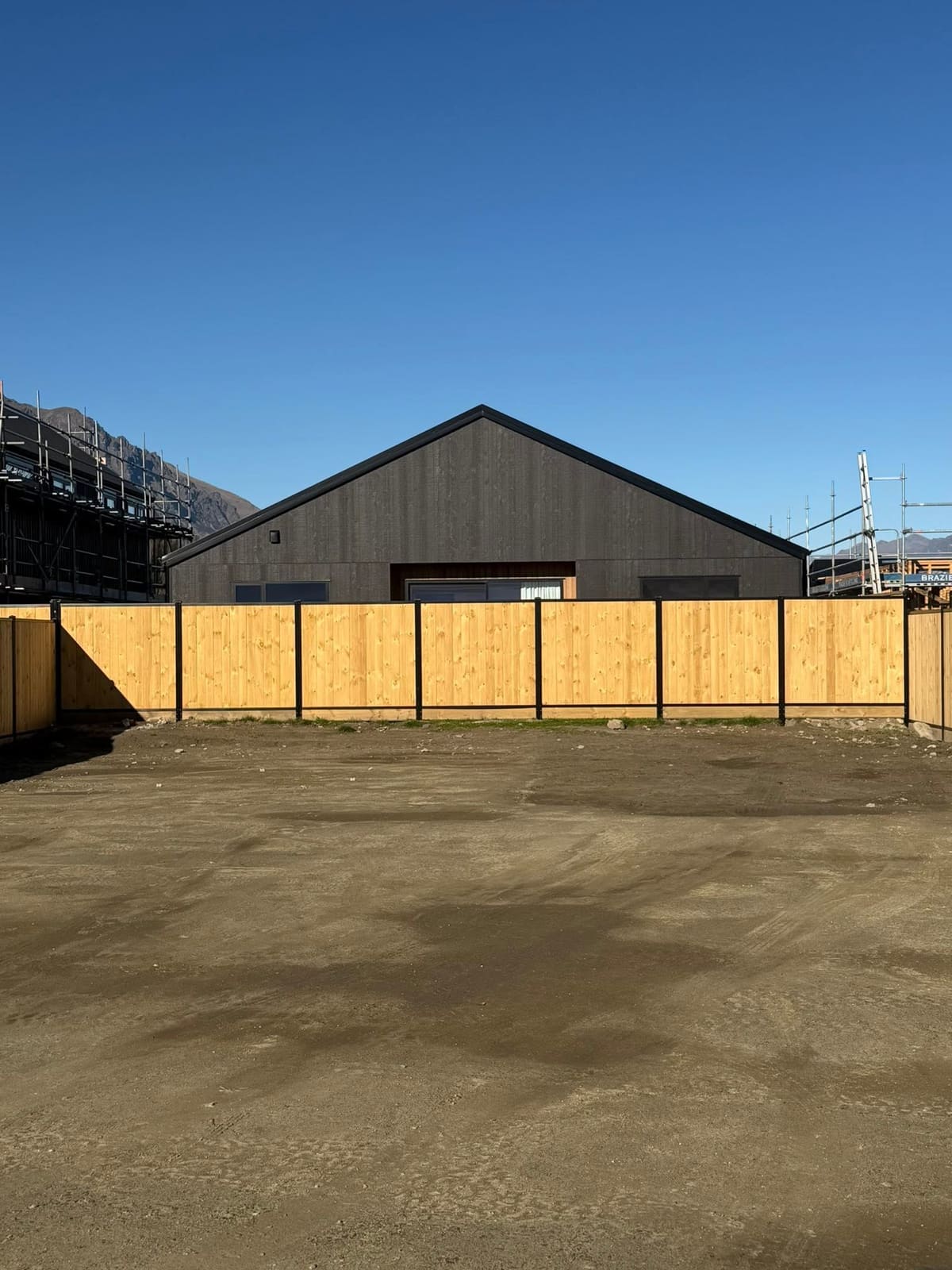 Smart wall fencing enclosing a completed Parkridge home, Queenstown