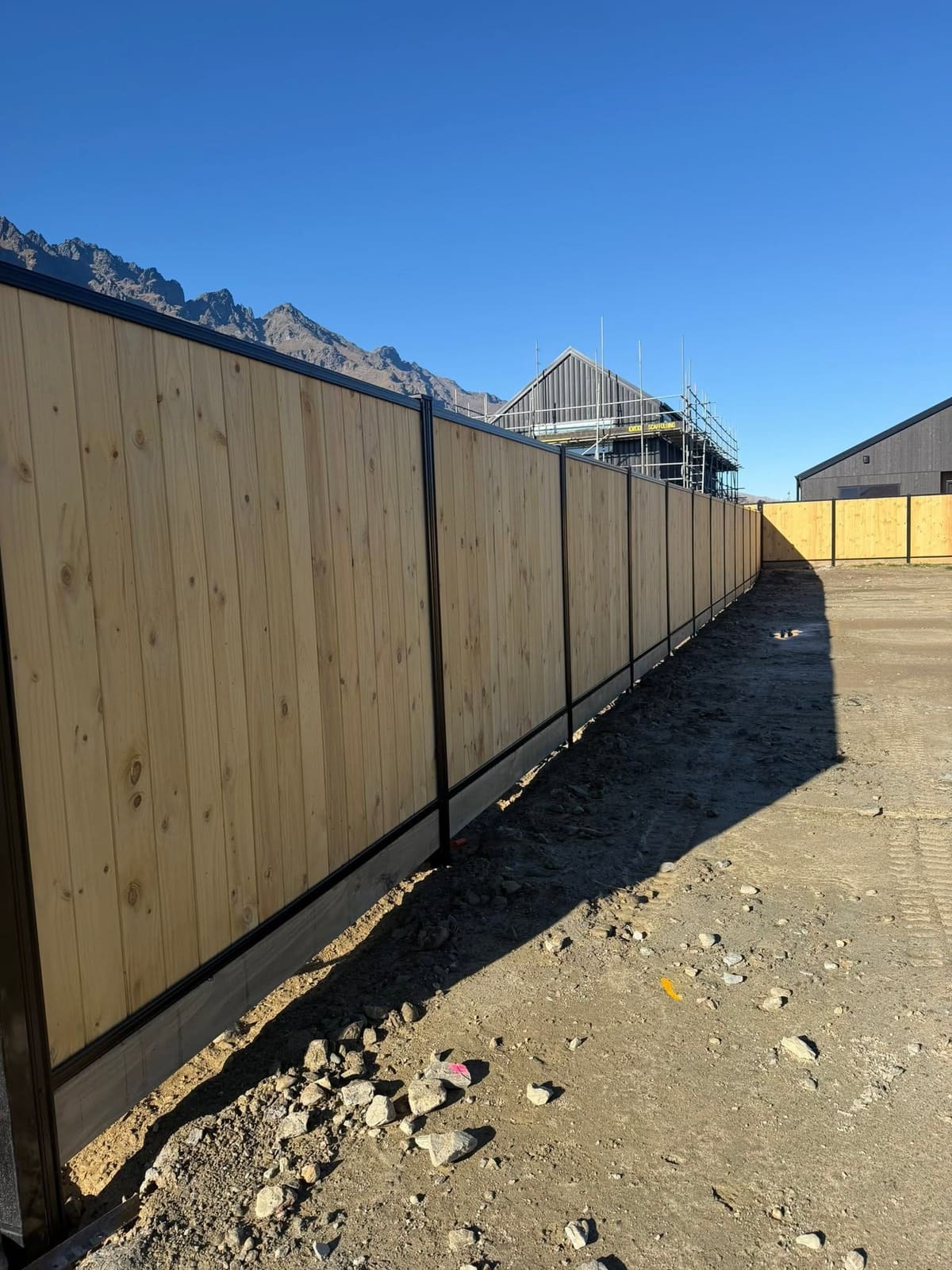 Long smart wall fence run at Parkridge subdivision with The Remarkables behind, Queenstown