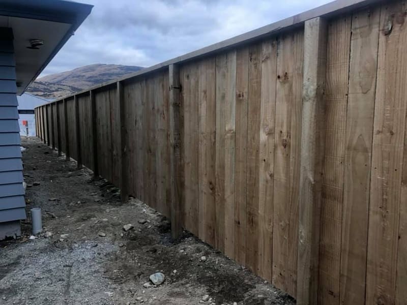 Timber paling fence with Shotover Fencing Solutions signage, Queenstown