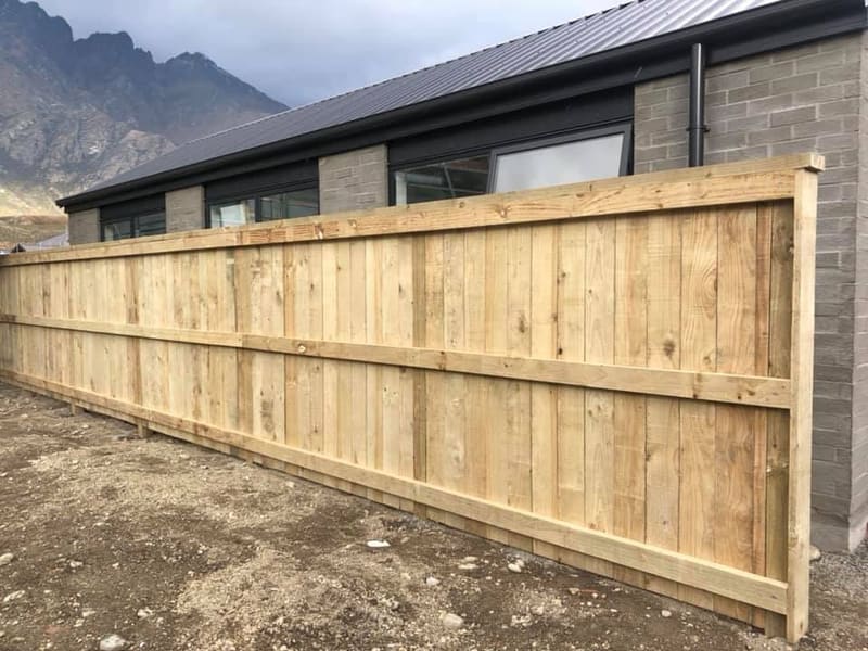 Long run of timber paling fencing on a Queenstown boundary