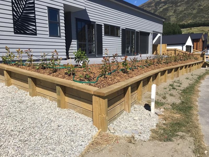 Timber sleeper retaining wall with a raised garden bed, Queenstown