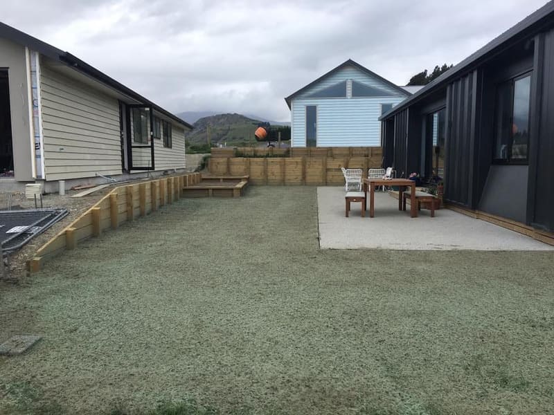 Timber sleeper retaining wall around a lawn and patio, Queenstown