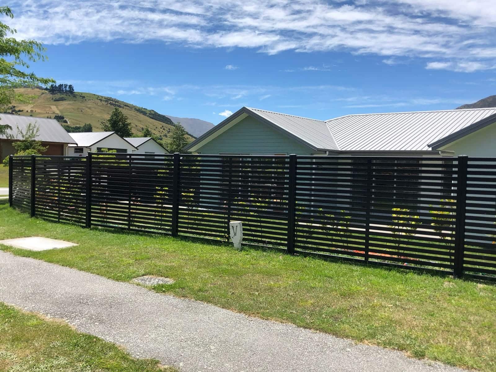 Dark horizontal slat fence with mountain views, Queenstown