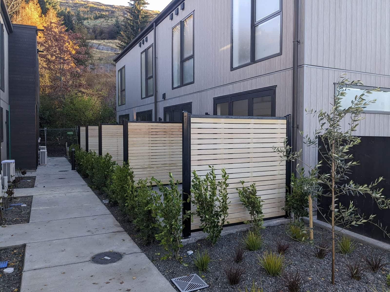 Cedar horizontal slat fence along a townhouse path, Queenstown
