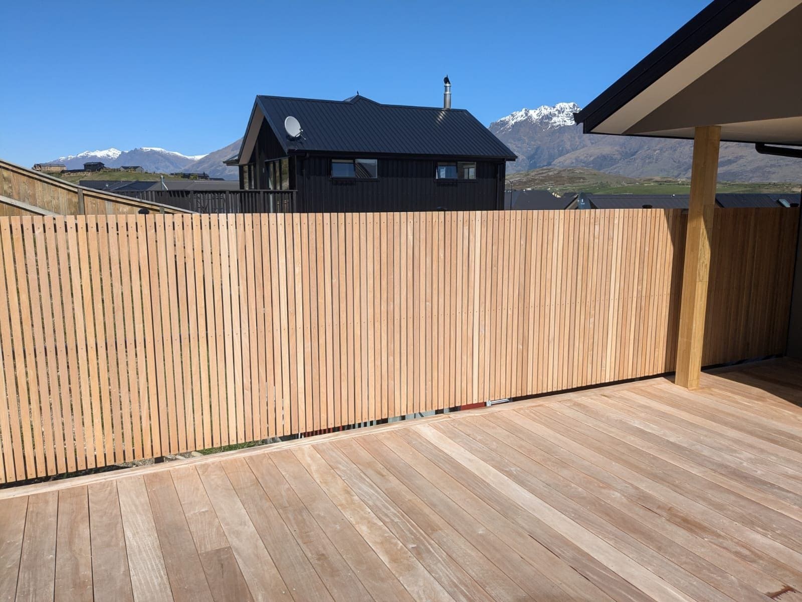 Vertical timber slat fence enclosing a new deck with The Remarkables behind, Queenstown