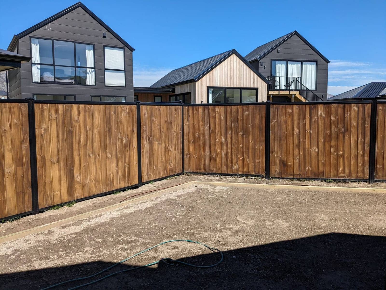 Smart wall fencing alongside modern Queenstown homes