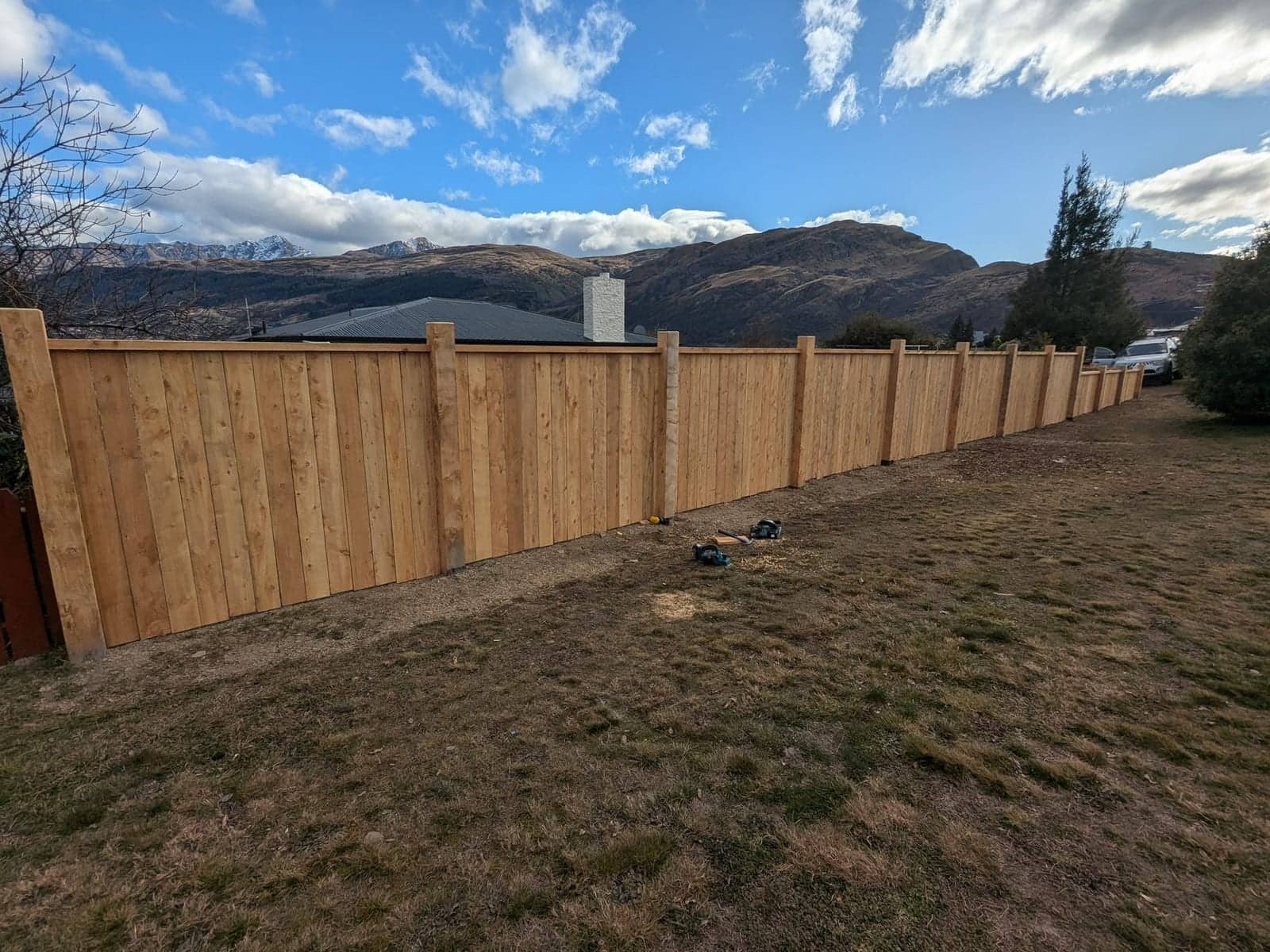 Capped timber paling fence with exposed posts and mountain views, Queenstown
